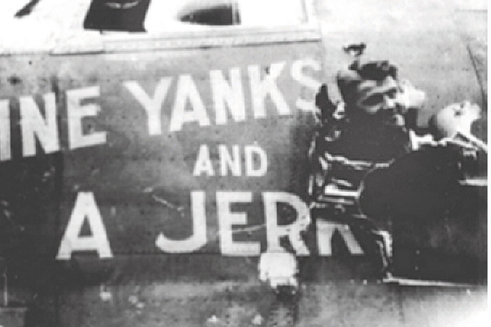 "Nine Yanks and a Jerk's" crew chief peers through the hole left by an unexploded anti-aircraft shell that narrowly missed Stewart. (Mike Simpson/445BG.org.)