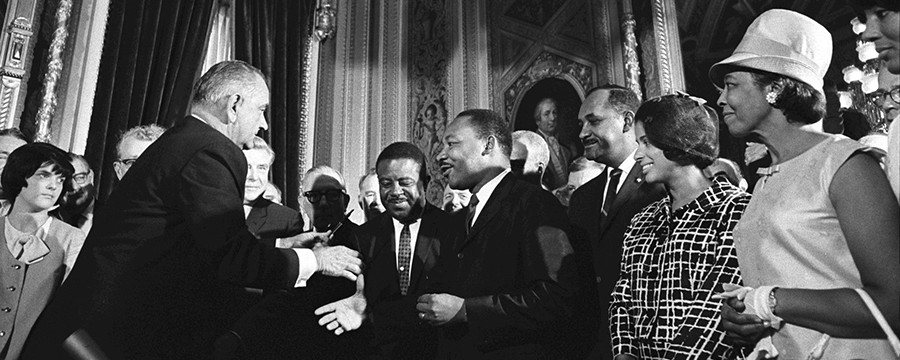 President Lyndon B. Johnson shakes hands with Dr. Martin Luther King after signing the Voting Rights Act. (LBJ Library photo by Yoichi Okamoto)