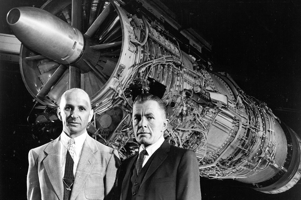 Gerhard Neumann (left) and Neil Burgess pose with a J79 turbojet, which earned them a Collier Trophy in 1958. (GE Photo)