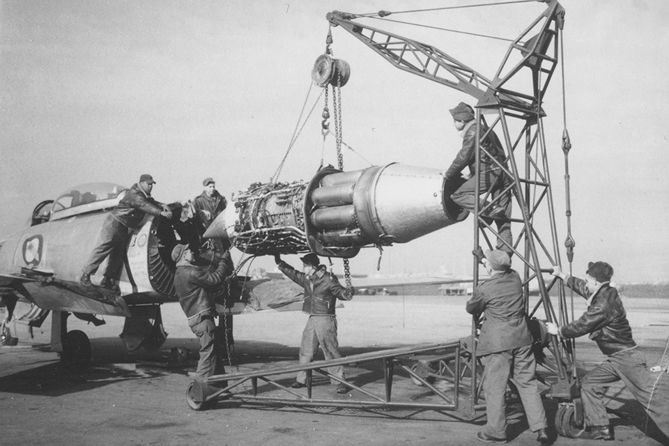 A North American F-86E of the 4th Fighter Interceptor Wing at an Air Base in South Korea, is split in two to replace its J47-GE-13 engine. (U.S. Air Force)