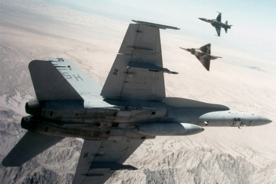 A U.S. Marine Corps F/A-18A Hornet prepares to mix it up with F-21A Kfir and F-5E aggressor aircraft in the skies near Marine Corps Air Station Yuma, Arizona, circa 1989. (U.S. Navy)