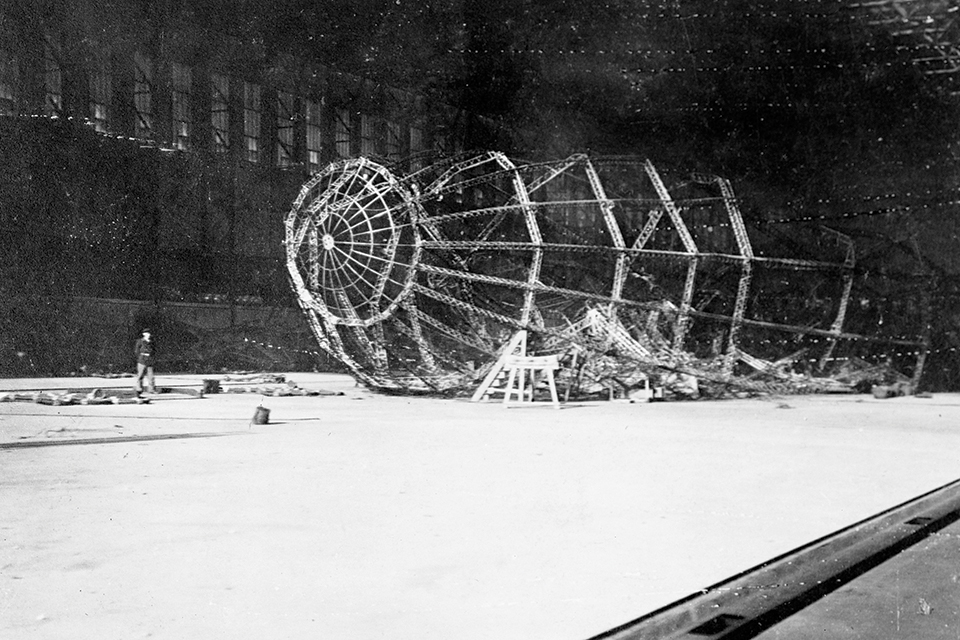 A German soldier surveys the remains of L54 in the wake of the British raid. (IWM Q47940)