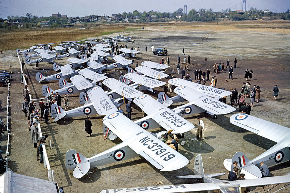 Piper J-3 Cubs, members of the Flitfire Brigade, gather at Flushing Field, N.Y., in support of the Royal Air Force Benevolent Fund. (NASM)