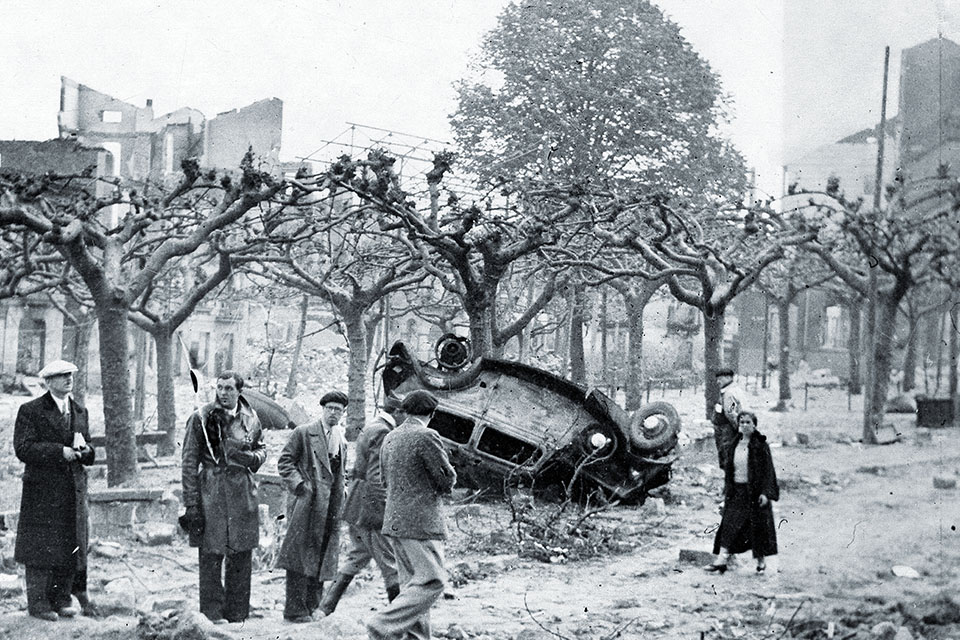 Survivors of the attack survey the ruins of their city. (Ullstein Bild/Getty Images)