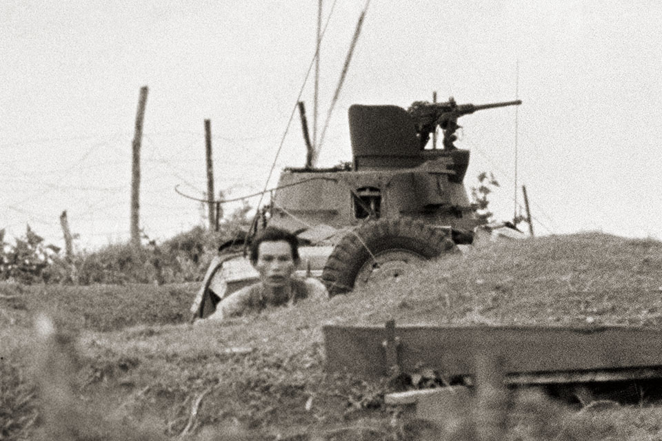 A Viet Cong fighter looks toward the camp during the intense gunbattle on June 10. (AP Photo/Horst Faas)