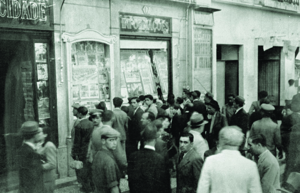 Residents of Lisbon, Portugal, seek the latest war news. Information was valuable currency in Lisbon, known to be a hotbed of espionage during the war. (© IWM (D 1103) )