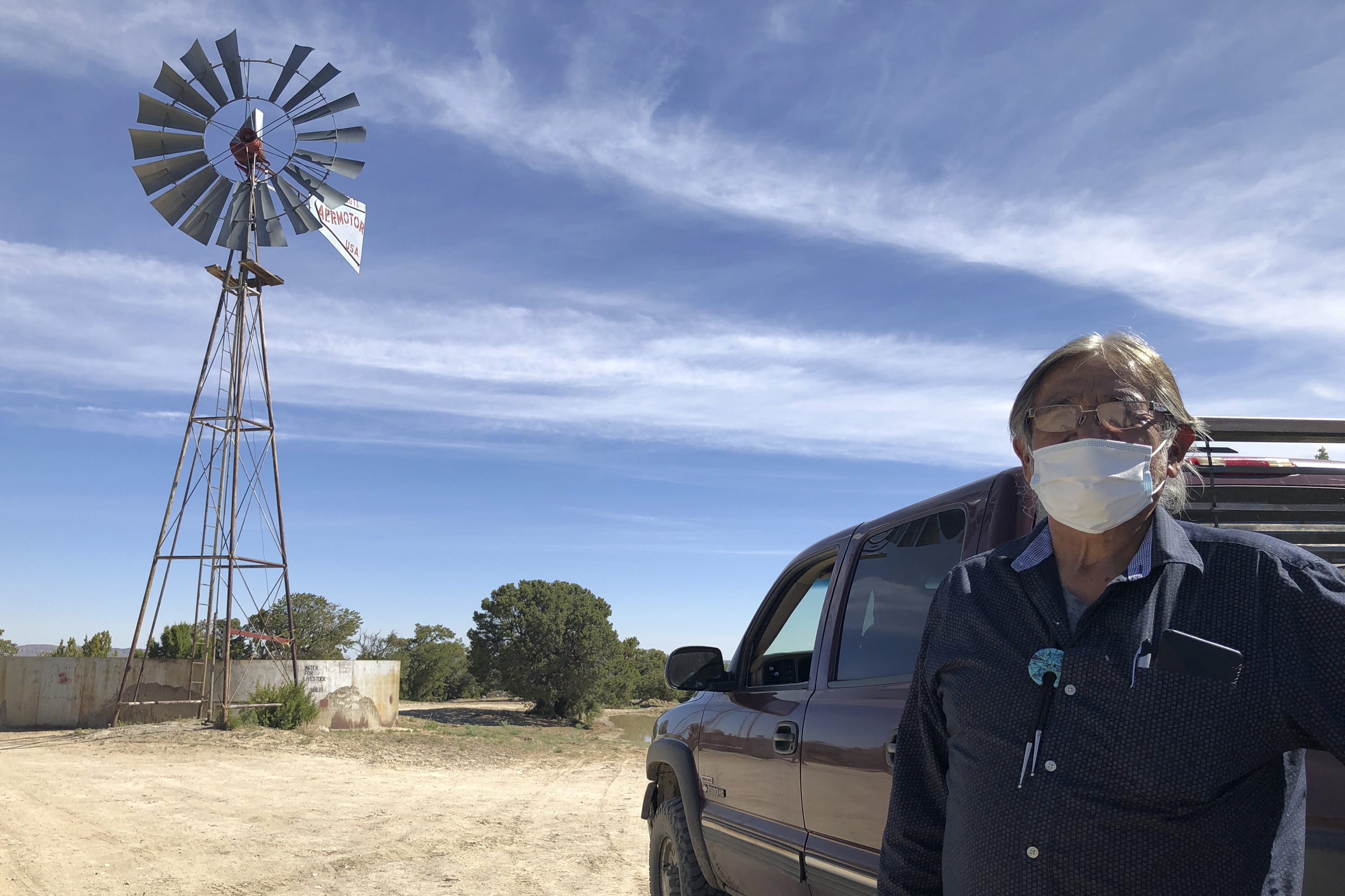 Johnnie Henry, president of the Navajo Nation's Church Rock chapter house community center, hauls drinking water to neighbors in Gallup, N.M. (Morgan Lee/AP)