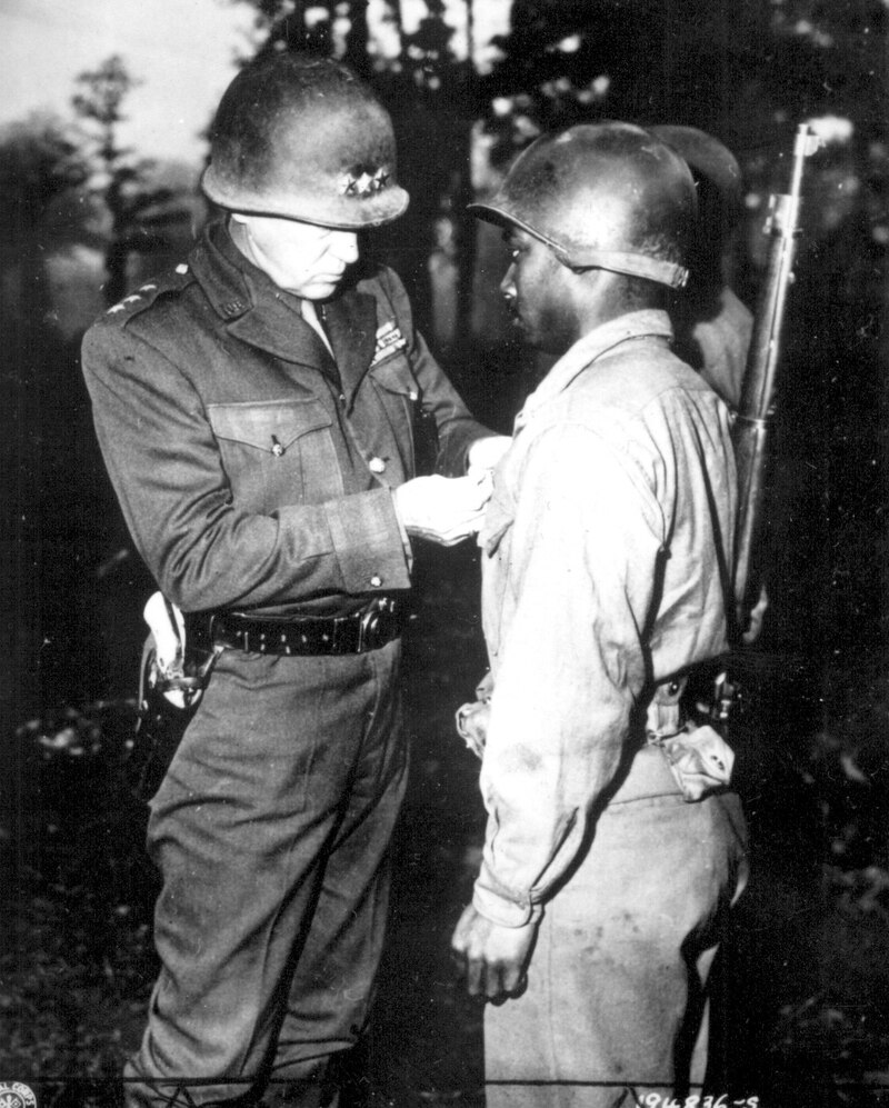 Lt. Gen. George S. Patton, U.S. Third Army commander, pins the Silver Star on Pvt. Ernest A. Jenkins of New York City on Oct. 13, 1944, for his conspicuous gallantry in the liberation of Chateaudun, France. (National Archives)