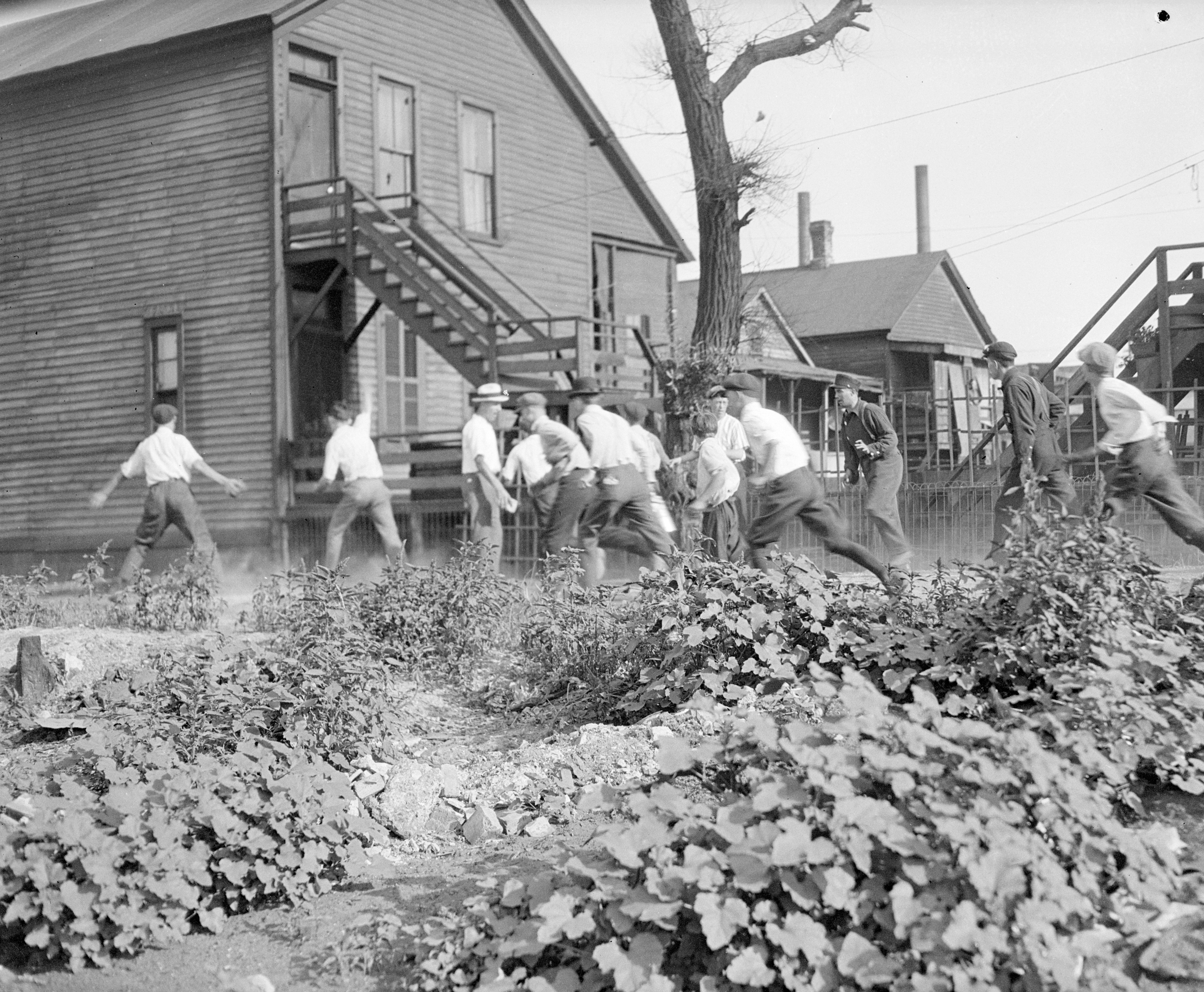 Rioters with bricks and stones pursue an African-American man during the riots in 1919. (Chicago History Museum/Getty Images)