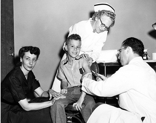Peter Salk receiving the polio vaccine from his father, Jonas Salk, in 1953. (March of Dimes Foundation)