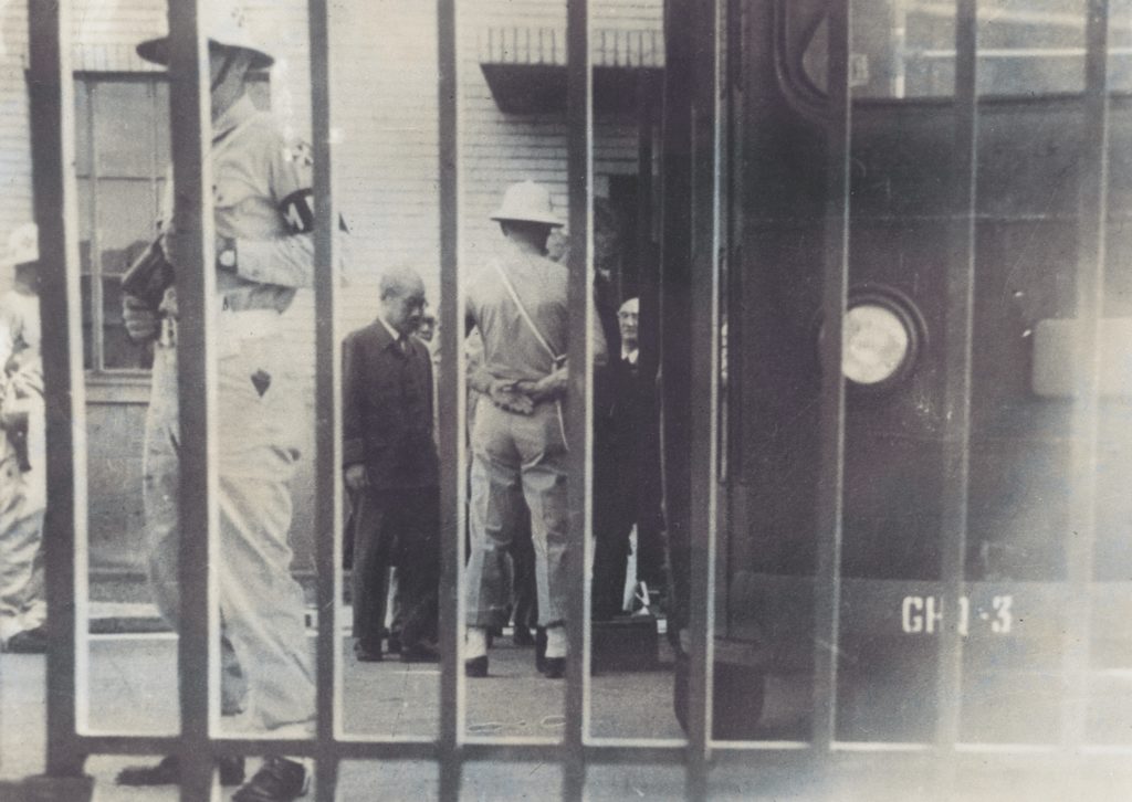 In a surreptitious photo taken by Case, guards escort General Hideki Tojo from his cell; he would be executed in late 1948. (Courtesy of Edgar W. Case)