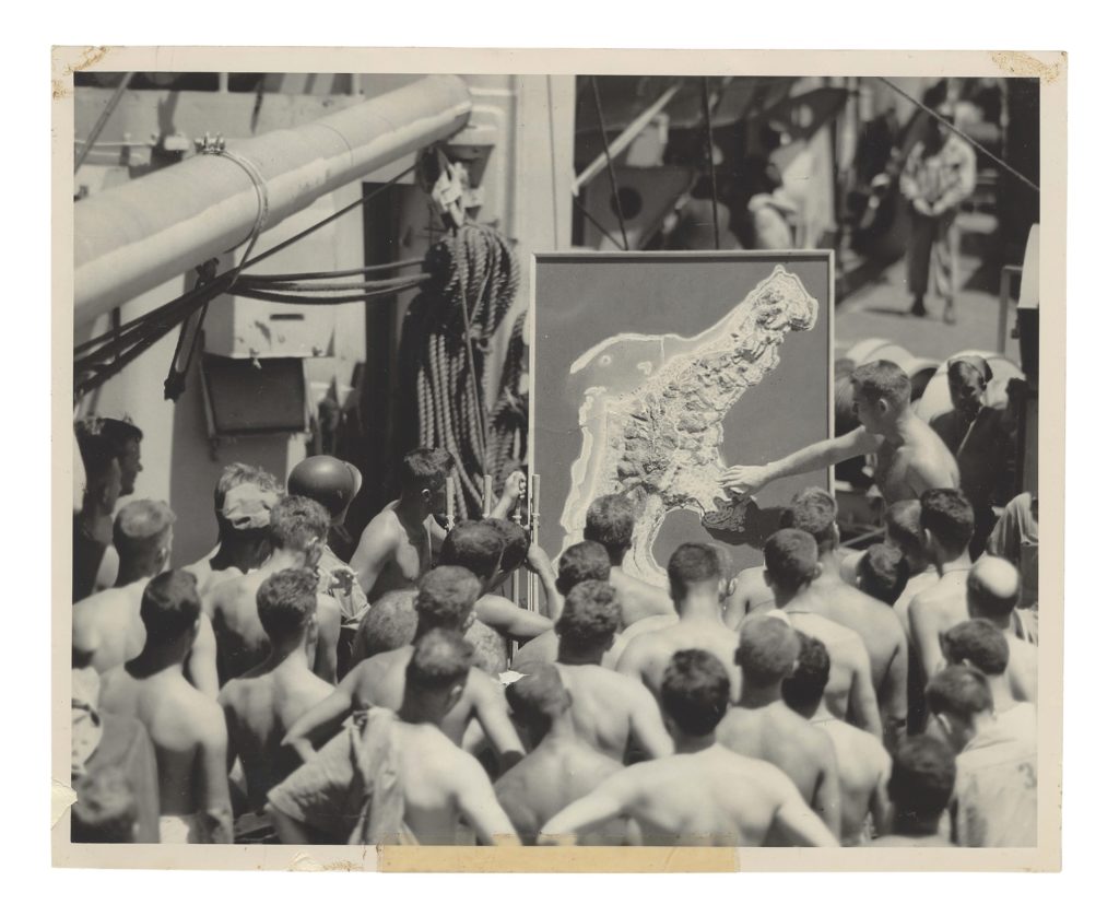 Headed to Saipan to reinforce Marines already fighting there, men of the 27th Division receive a shipboard orientation lecture. (The New York State Military Museum)