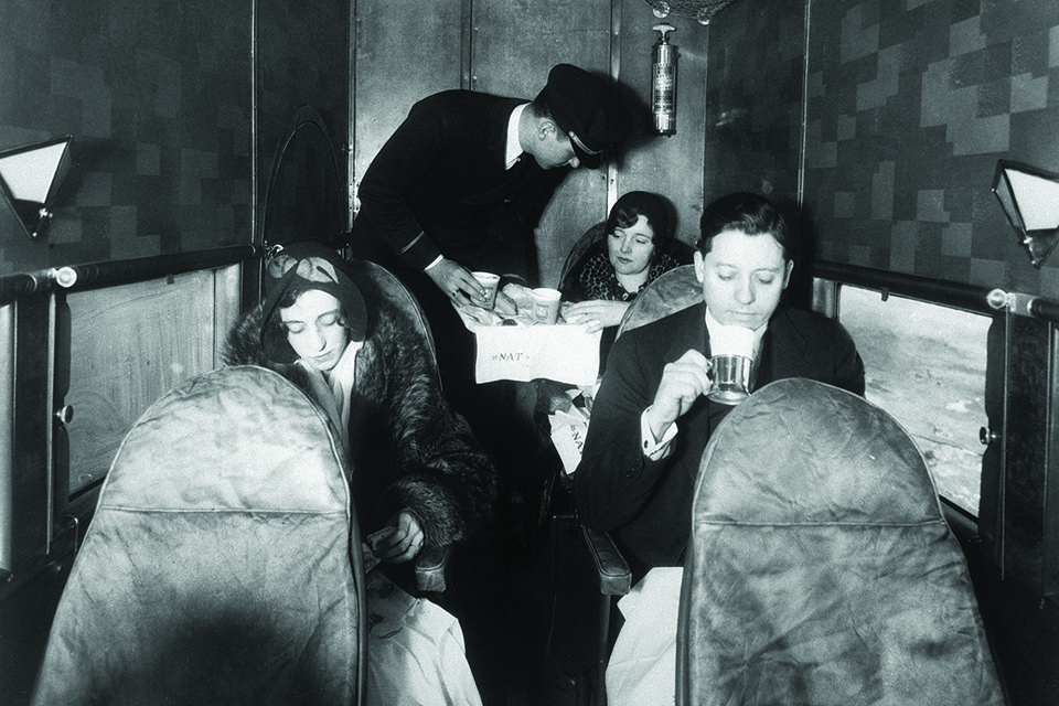 A crewman serves sandwiches, coffee, tea and milk on a National Air Transport 4-AT in 1930. (Bettmann/Getty Images)