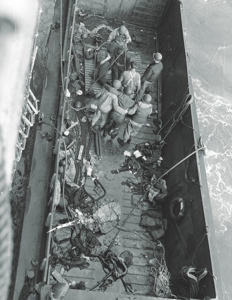Casualties are transferred from an LCM to a larger ship for evacuation  from the Normandy landing beaches. (Naval History and Heritage Command)
