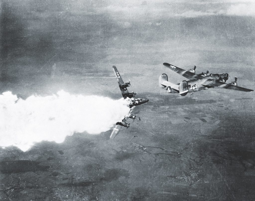 The nightmarish scenes Stewart witnessed during the war—B-24s battered and burning (like those above and below) and men dying—haunted his dreams in the years to follow. (National Archives)