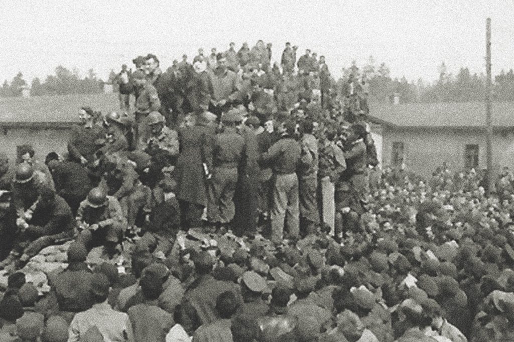 Former POWs celebrate the liberation of Stalag VII/A on April 29, 1945. “We were miserably housed, always hungry, usually too cold,” the author writes of his time as a POW. But he believed a happy ending would come, and it did. (U.S. Air Force Library Special Collections)