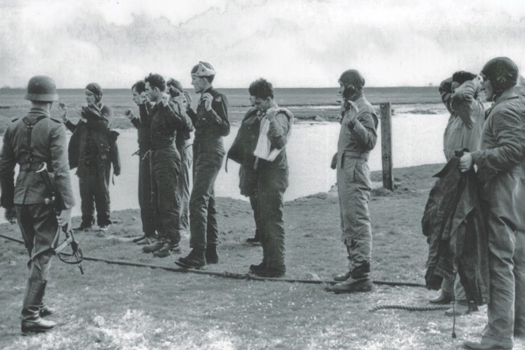 Luftwaffe personnel capture a group of American airmen (top). The author and fellow crewmen of Ole Worrybird spent time in several POW camps before winding up in the large Stalag VII/A in Moosburg, Germany, source of the ID tags below. (© 2012 MFA Productions LLC)