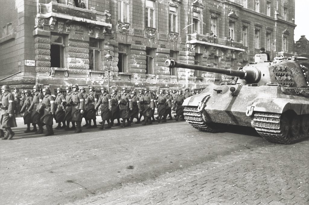German-backed Arrow Cross troops (above) march in Budapest in September 1944; Hitler deposed and detained Horthy the following month. The Americans  saved Horthy from execution when they arrested him in 1945 (below). (Bundesarchiv Bild 101I-680-8283A-12A Photo Faupel)