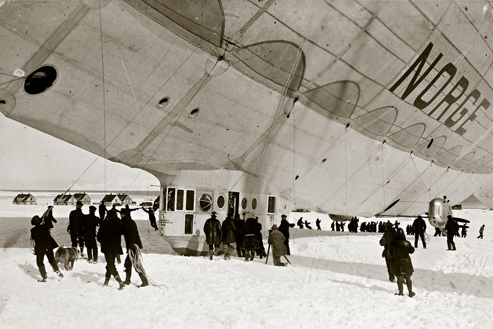Roald Amundsen, framed by Norge’s control cabin door, meets the press prior to the historic flight. (National Library of Norway)