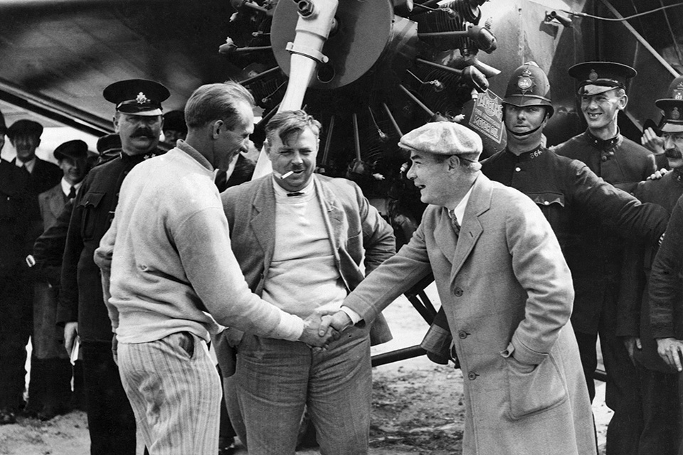 After their transatlantic crossing, Schlee shakes hands with an official at England’s Croydon aerodrome while Brock looks on. (Watford/Mirrorpix via Getty Images)