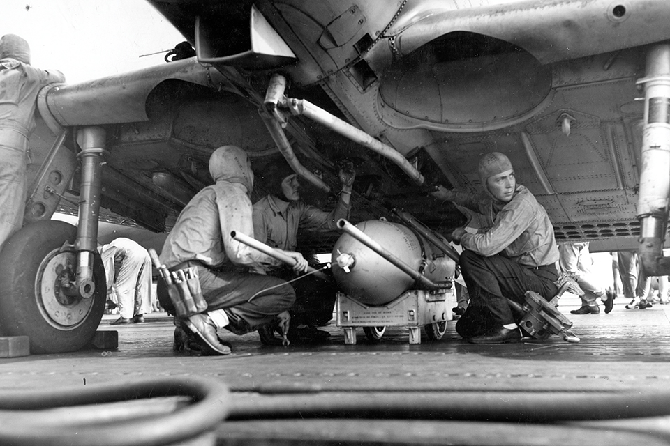 Crewmen load a 500-pound bomb onto an SBD aboard the aircraft carrier USS Enterprise on August 7, 1942, the first day of strikes against Guadalcanal and Tulagi. (Naval History and Heritage Command)