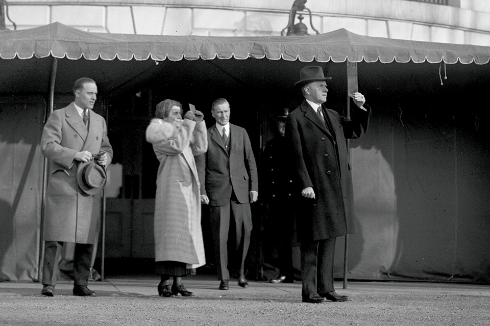 President Calvin and First Lady Grace Coolidge view the eclipse from outside the White House. (Library of Congress)