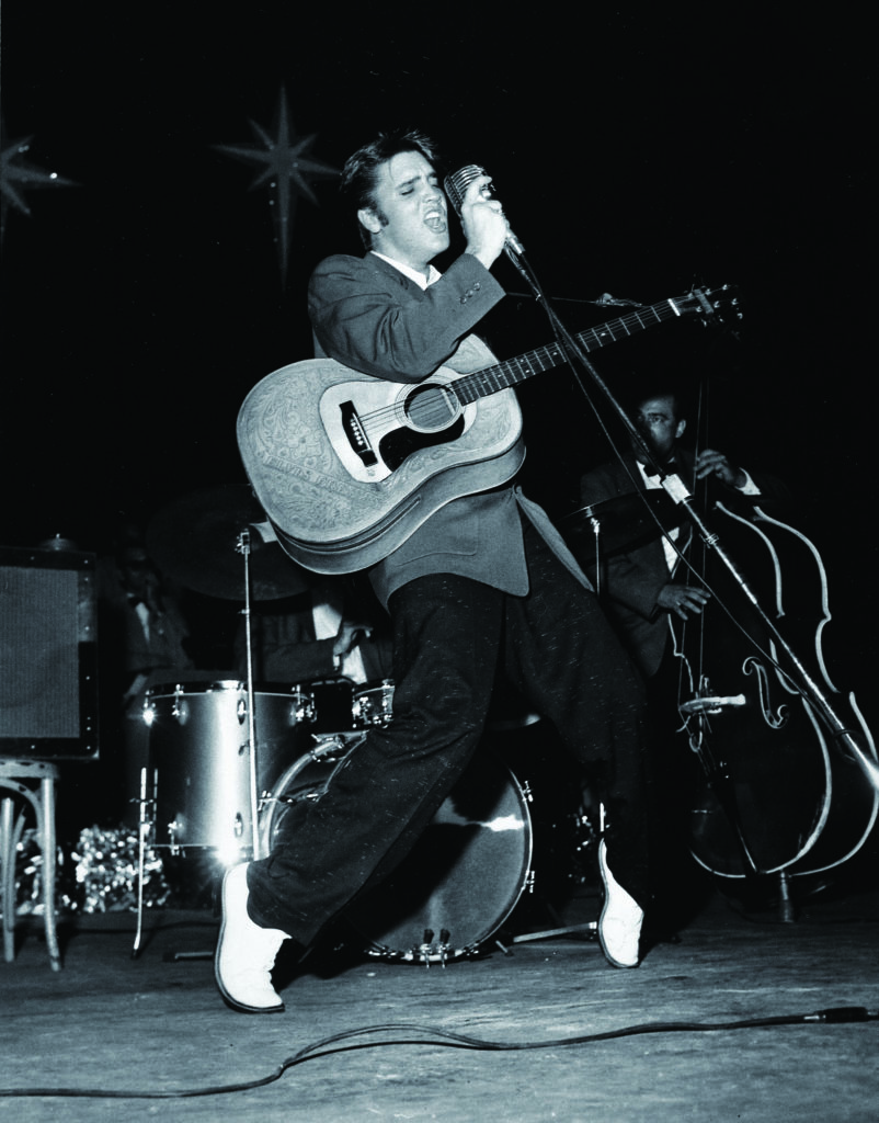 Performing transformed Elvis—here in Miami's Olympia Theater, August 1956—from a shy mumbler into a gyrating fireball with an unbelievably sexy sneer. (The LIFE Images Collection via Getty Images)