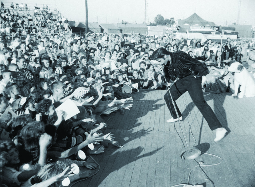 Elvis Presley performs to the adulation of a young crowd circa 1957. (Hulton Archive/Getty Images)