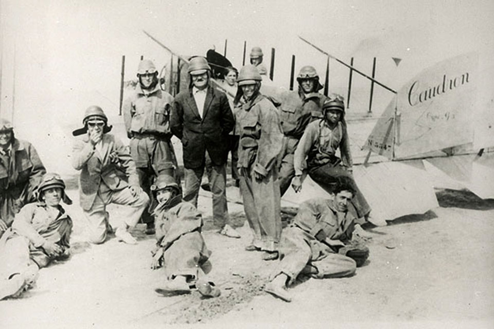 Flight students at the École d'Aviation des Frères Caudron at Le Crotoy, France, standing beside a Caudron Type G3. Bessie Coleman is sitting on the rear elevator. (NASM 94-13746)