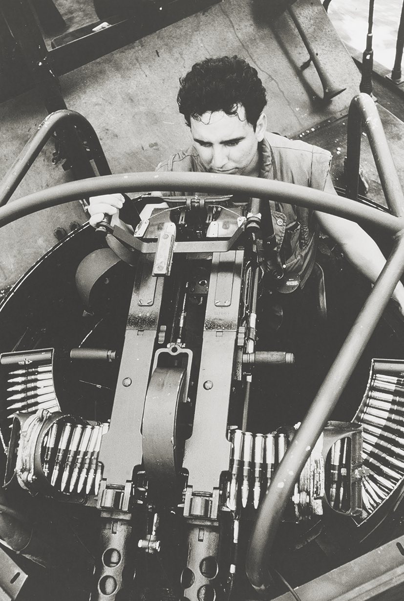 A PBR crewman operates his twin .50-caliber machine gun mount on patrol in the Mekong River on April 14, 1966. Some PBR crews added extra weapons to their PBR. But there was a trade-off: reduced speed. / Naval History and Heritage Command