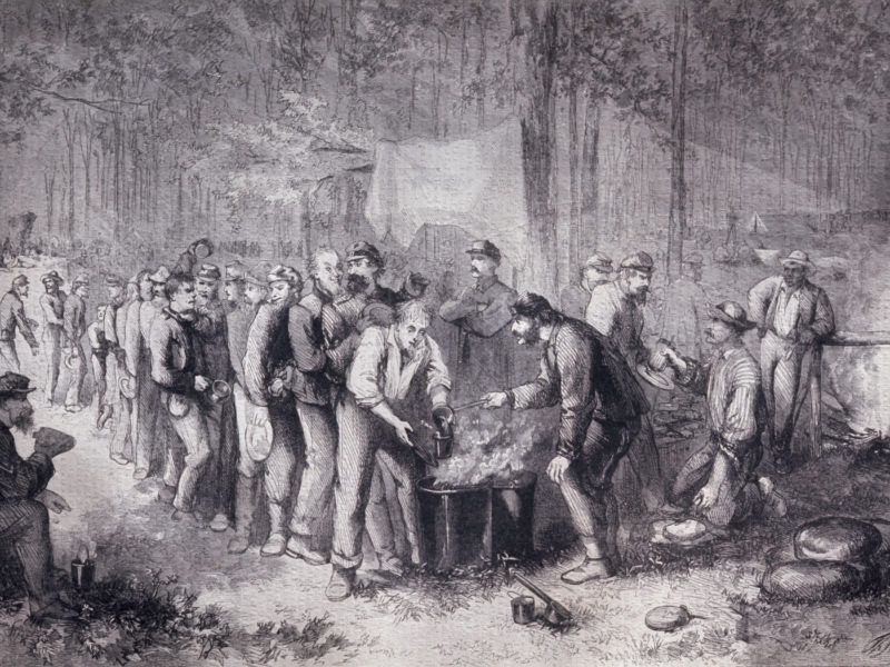 Soldiers being served vegetable soup