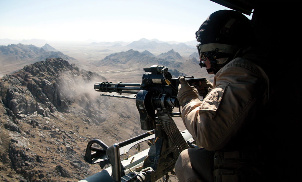Photo of U.S. Marine Corps Sgt. Samuel Galan, a UH-1Y Venom crew chief assigned to Marine Light Helicopter Attack Squadron (HMLA) 169, opens fire while conducting an interdiction mission over Helmand province, Afghanistan, Feb. 3, 2013. Galan, from Houston, Texas, is deployed to Afghanistan in support of Operation Enduring Freedom. (U.S. Marine Corps