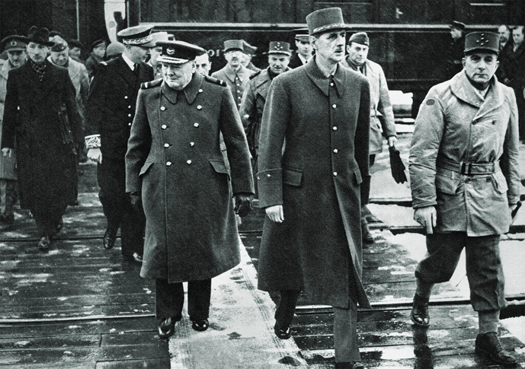 Photo of Winston Churchill inspecting units of the French army at Besancon with de Gaulle and General de Lattre de Tassigny. 3oth November 1944.