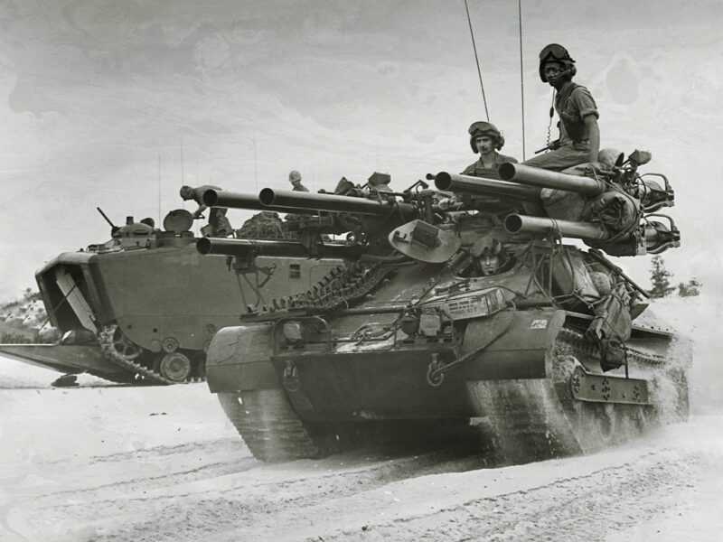 Photo of American forces on Chu Lai beach searching for a defensive position shortly after descending from the landing crafts aboard the USS Thomaston. Vietnam, June 1965.