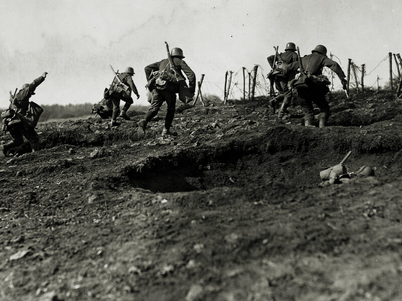 Photo of German storm troops laden with equipment have to advance over open but broken ground. The enemy know of their approach because of a preliminary barrage.