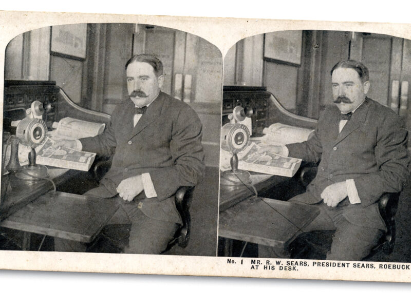 Stereographic view of R.W. Sears at desk.
