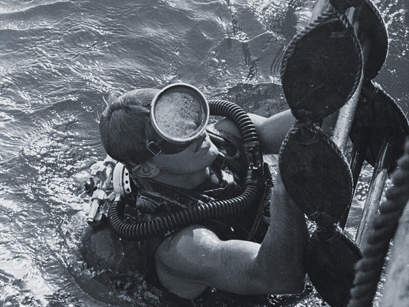 Photo of a U.S. Navy SEAL surfacing from a dive. SEALs and UDT divers were tasked with getting ashore and guiding the POWs to safety.