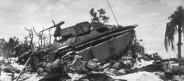 Marines found protection behind a knocked-out LVT on Orange beach (Photo: U.S. Marine Corps)..