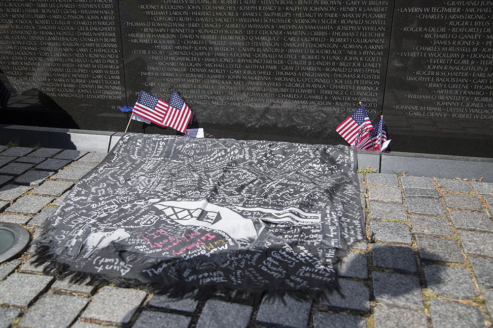 Tattered from its many miles on the run with Bowen, a POW flag, signed by people from Bowen's hometown, was left at The Wall, as a remembrance of their support when Bowen finished the run.